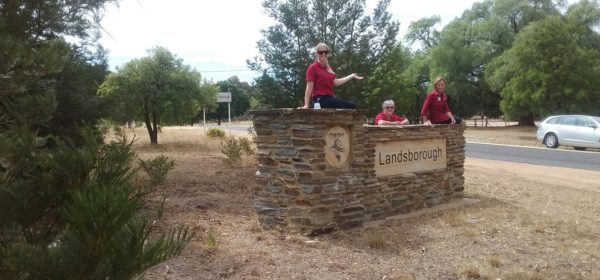 Stawell Regional Health Allied Health staff sitting on and leaning against the Landsborough entrry sign